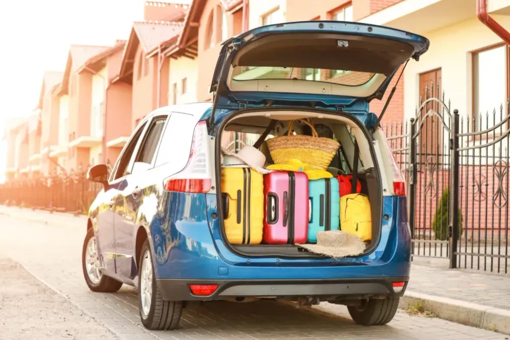 Car trunk loaded with colorful luggage